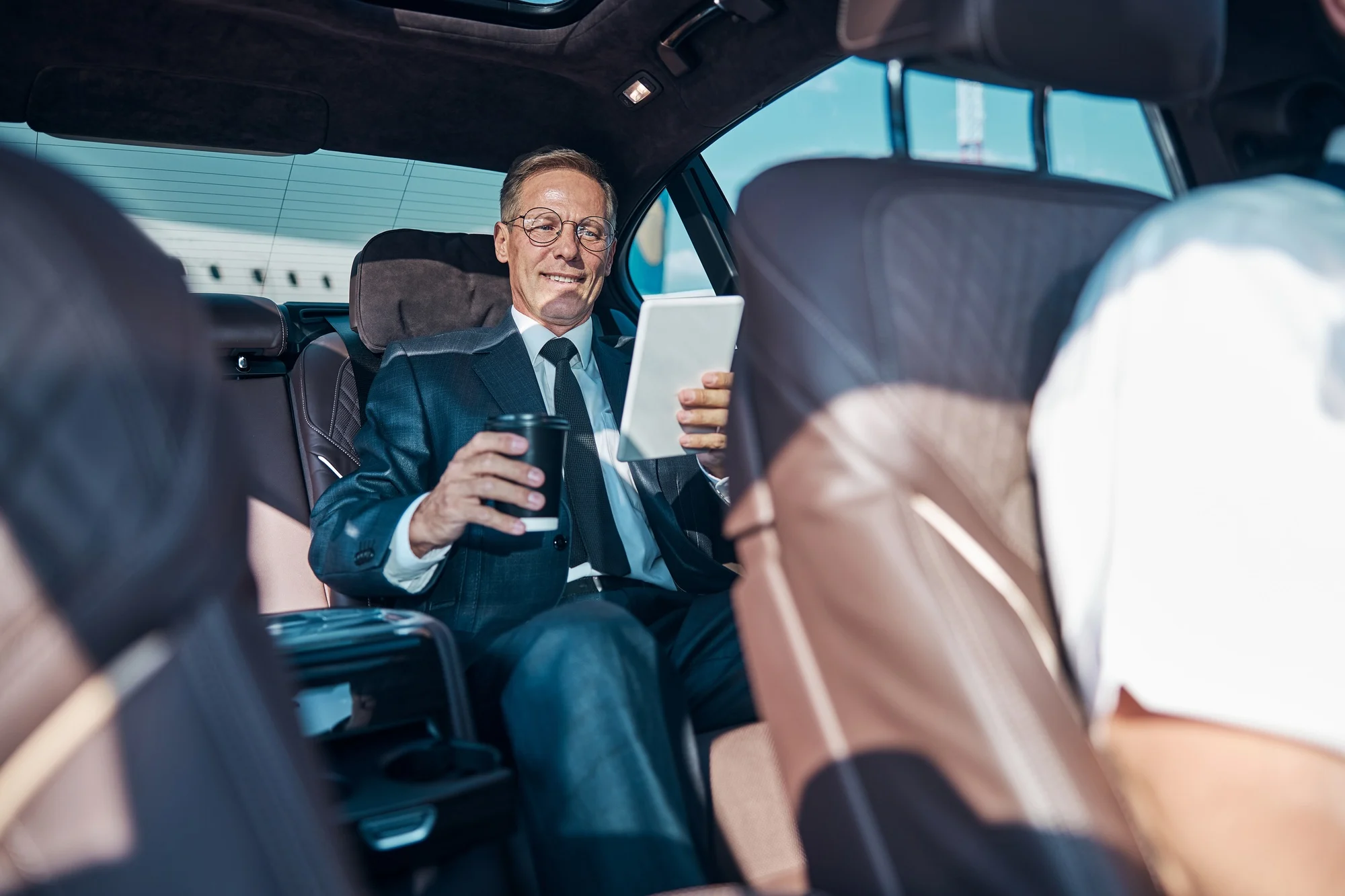 Happy businessman relaxing during transfer from airport